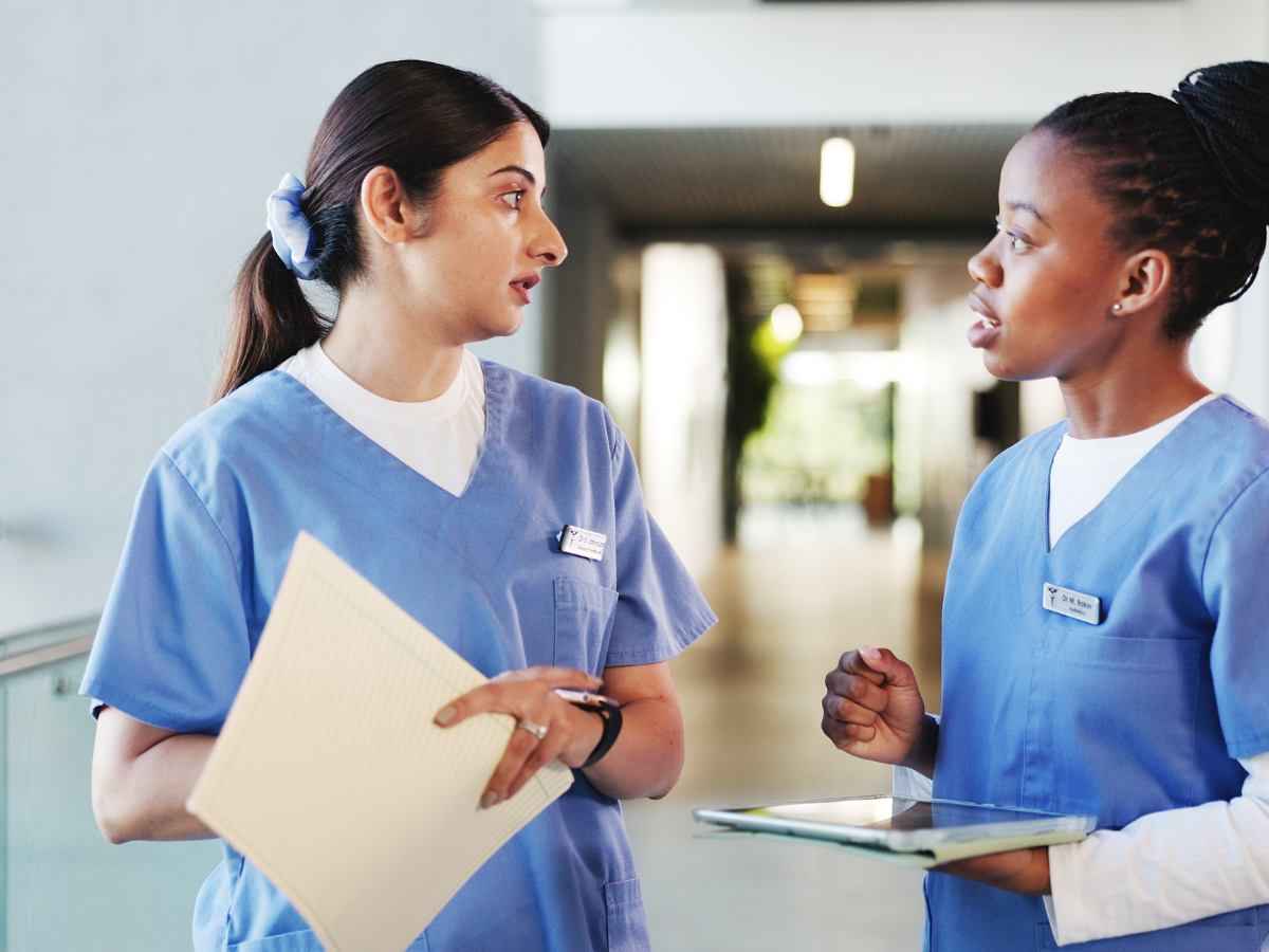 Supervisor and employee talking in a frontline workplace