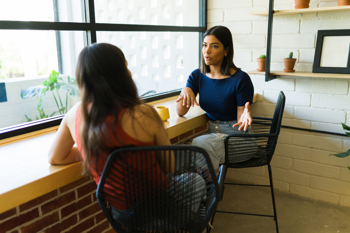 Two coworkers having a workplace conversation